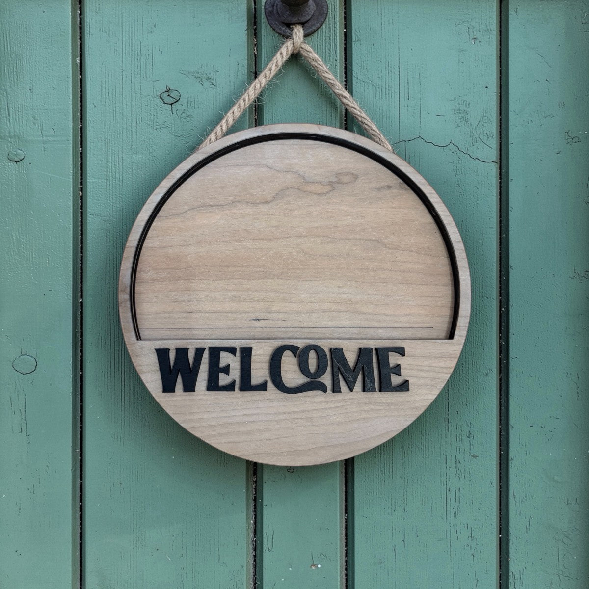 C2 Creative Crafts 10.5 inch round wooden door hanger with black "WELCOME" lettering and rope hanger.