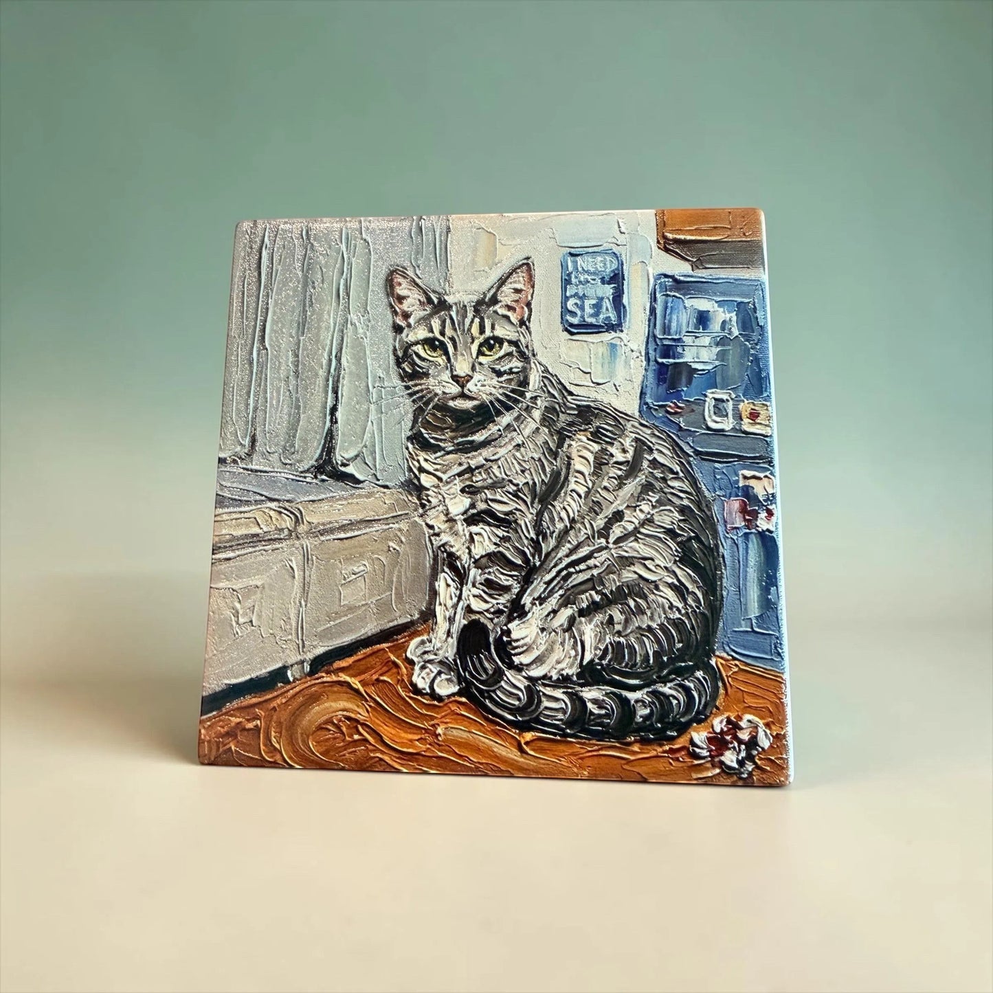 C2 Creative Crafts custom pet portrait ceramic tile artwork of a tabby cat sitting on a wooden surface with a textured background.