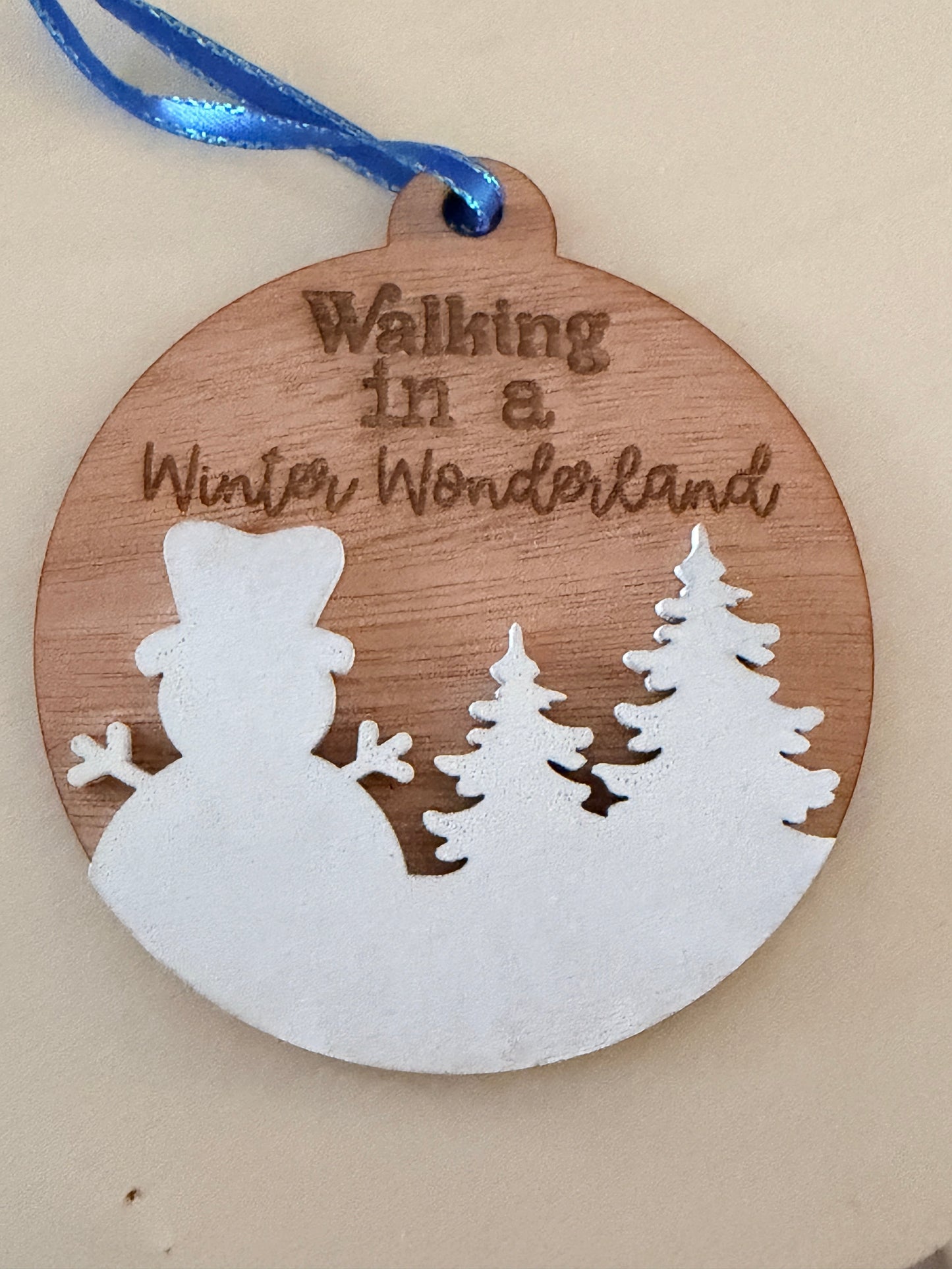 C2 Creative Crafts wooden snowman ornament with "Walking in a Winter Wonderland" text and pine trees. White finish.